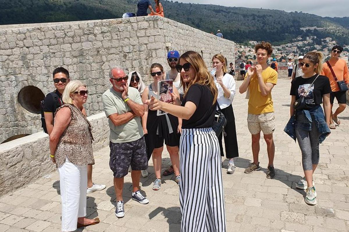 a group of people standing on top of a wall