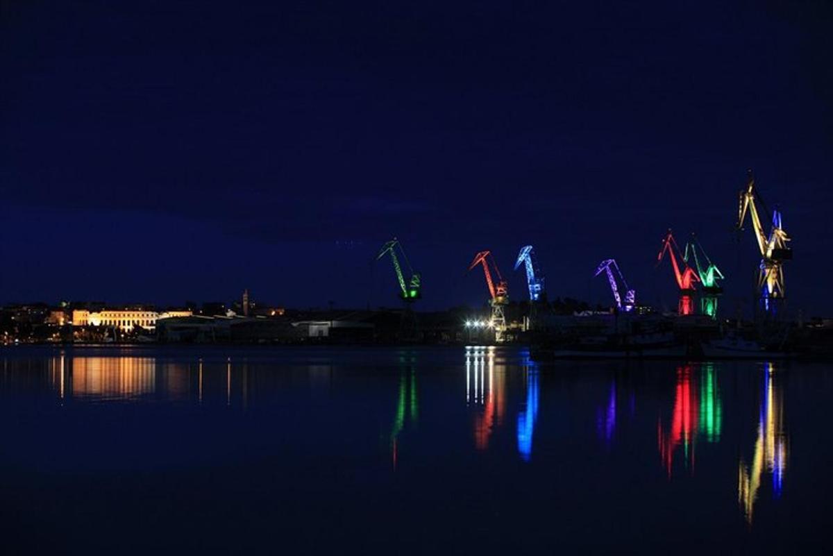 a group of colorful lights on the water at night