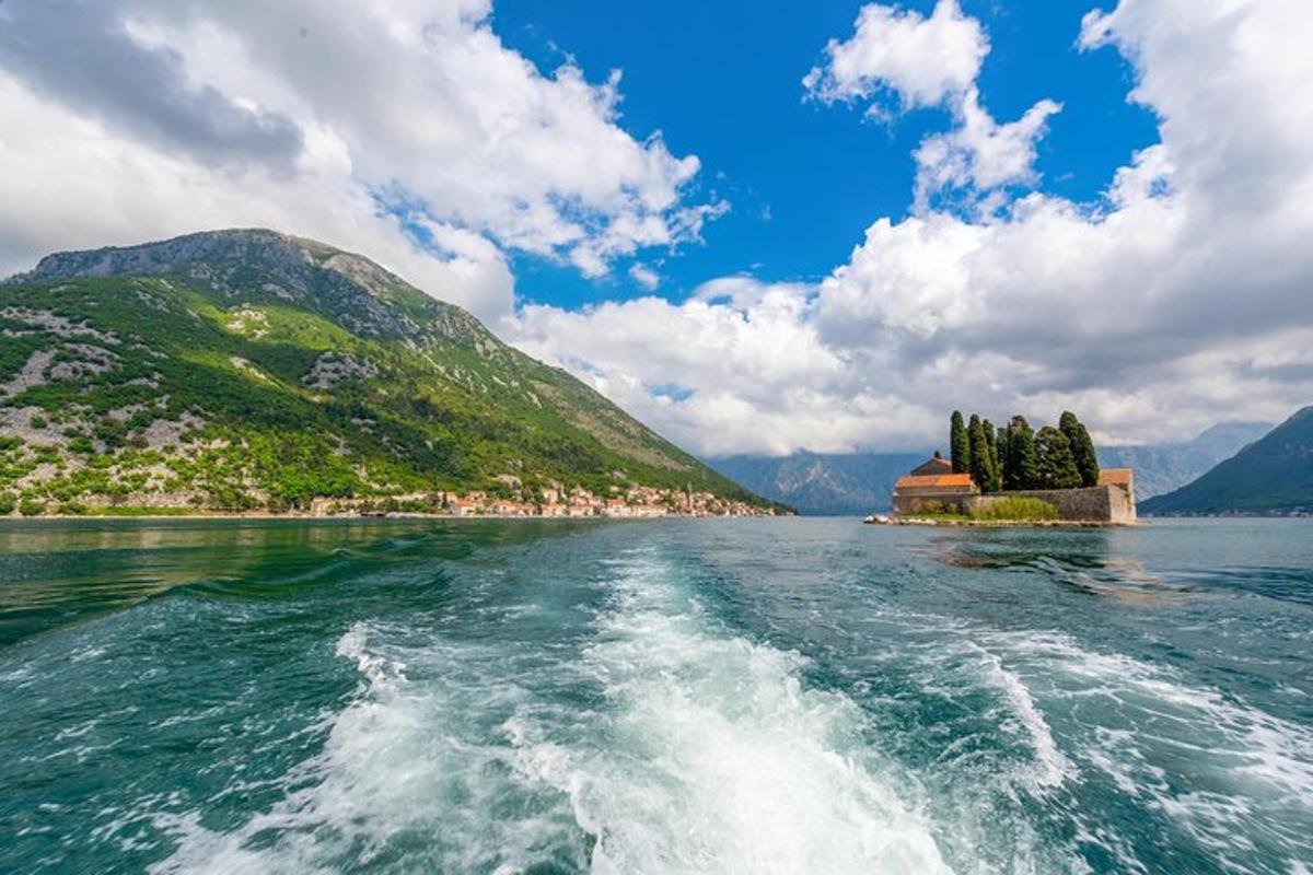 a boat in a body of water with a small island
