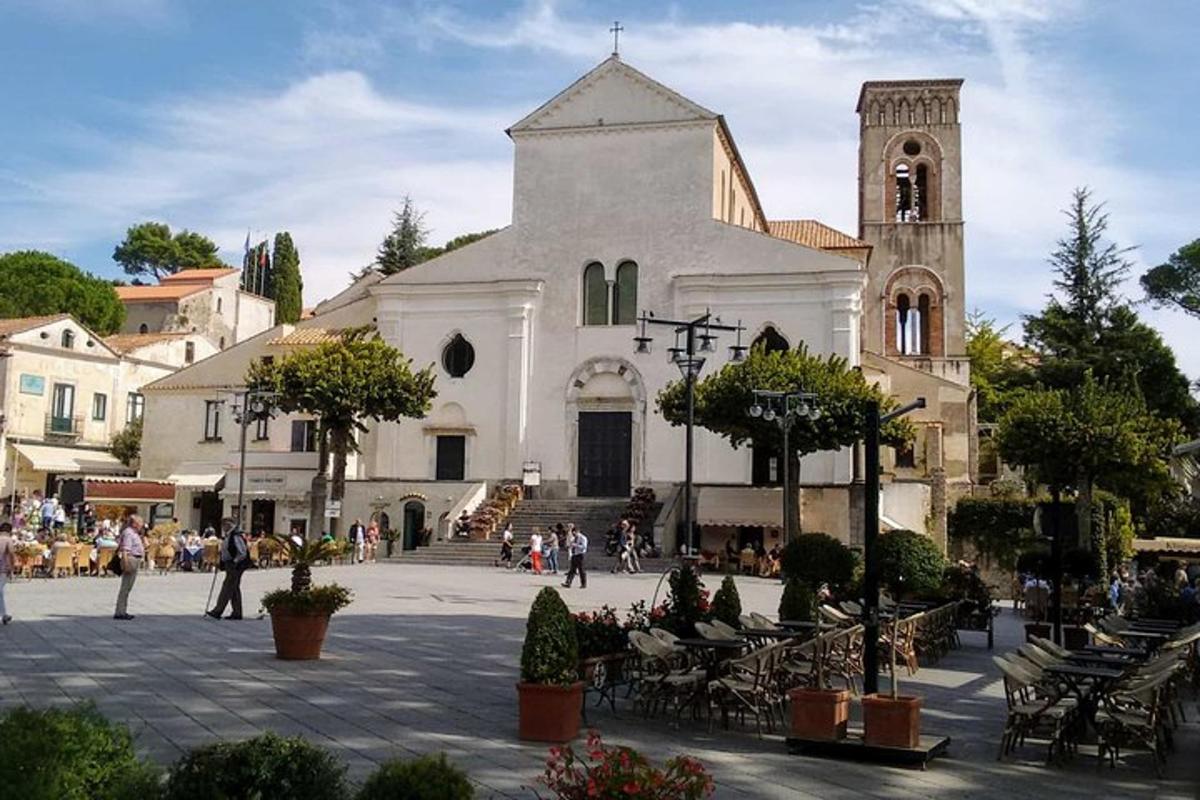 a large white church with a clock tower on a street