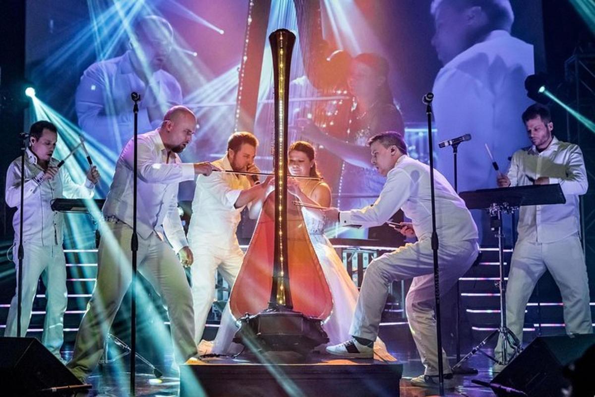 a group of people on a stage playing a musical instrument