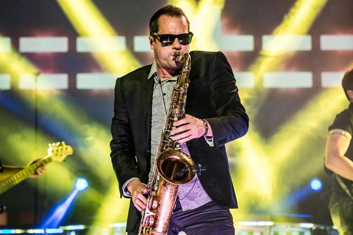 a man playing a saxophone on a stage