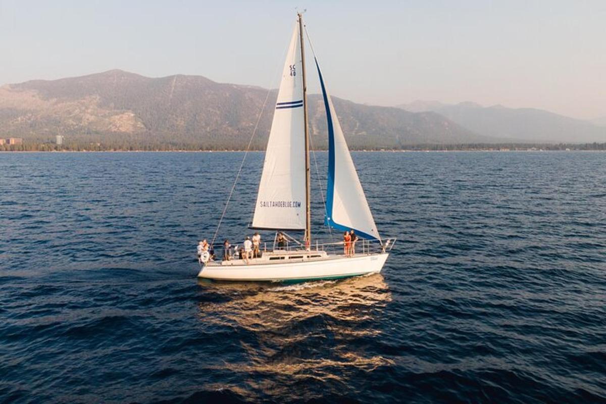 a group of people on a sail boat in the water