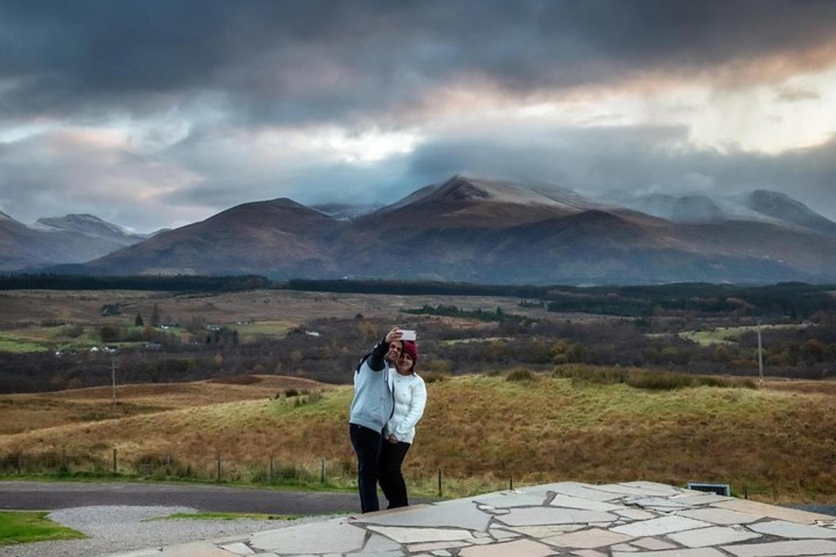 a woman is standing on top of a mountain