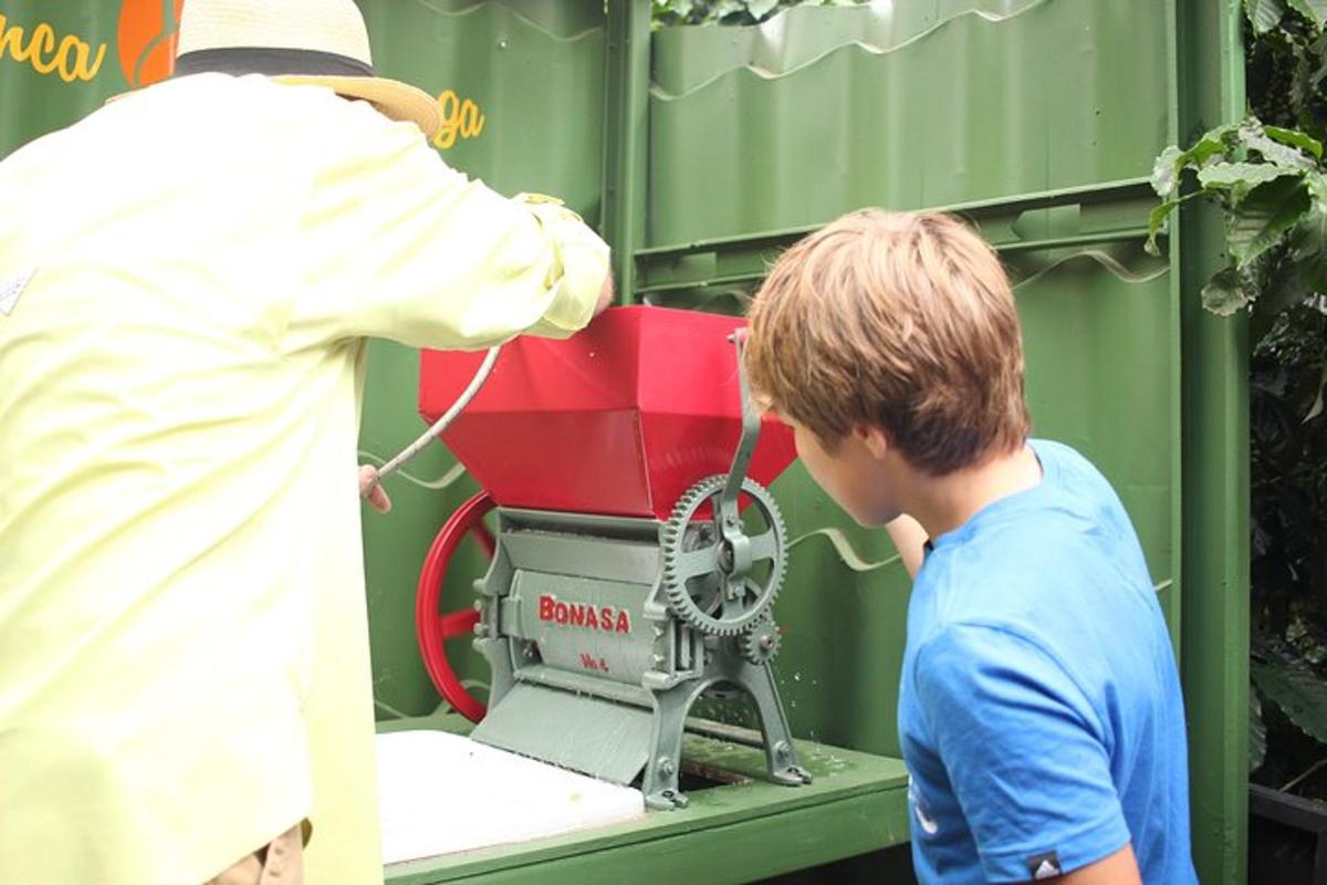 a young boy is standing next to a machine