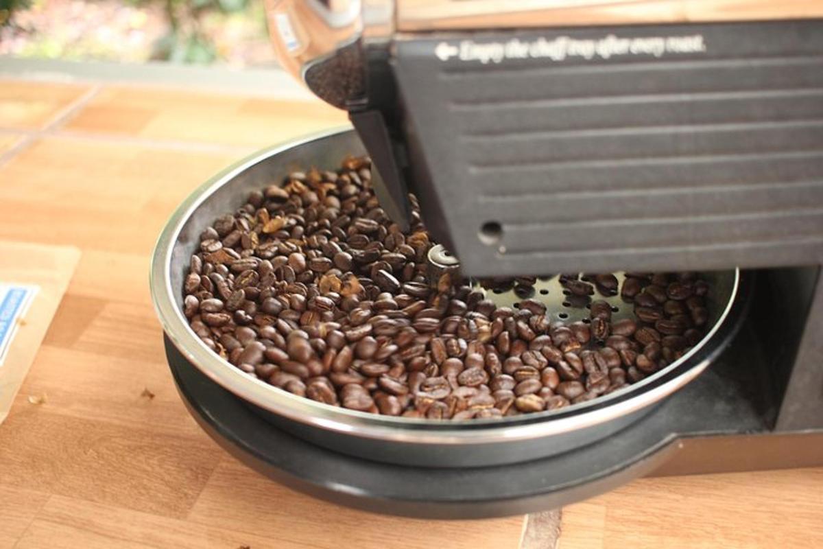 a coffee maker is making coffee beans in a pan