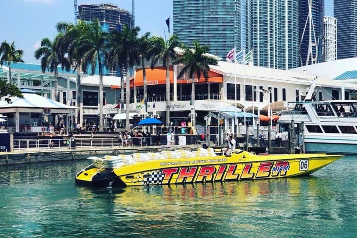 a yellow boat in the water next to a city