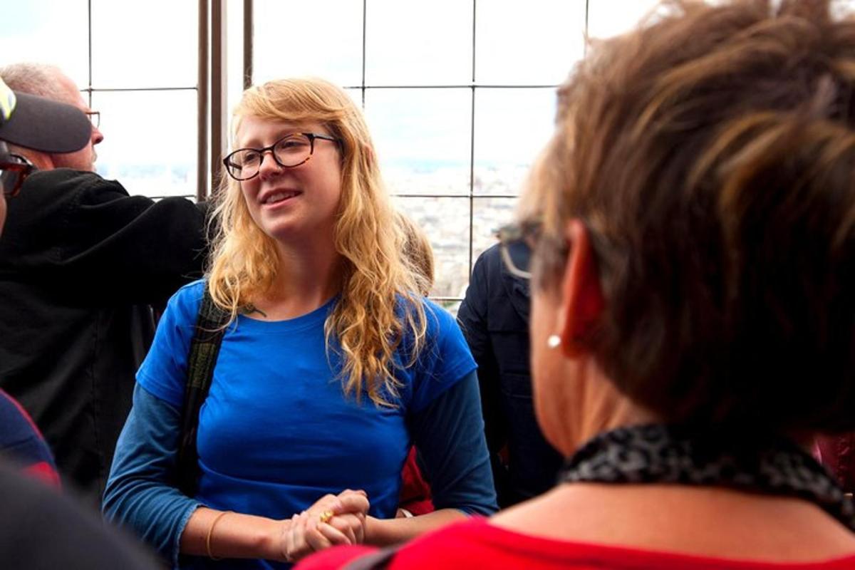 a woman wearing glasses sitting next to another woman