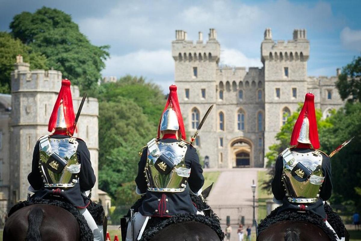 two people on horses in front of a castle