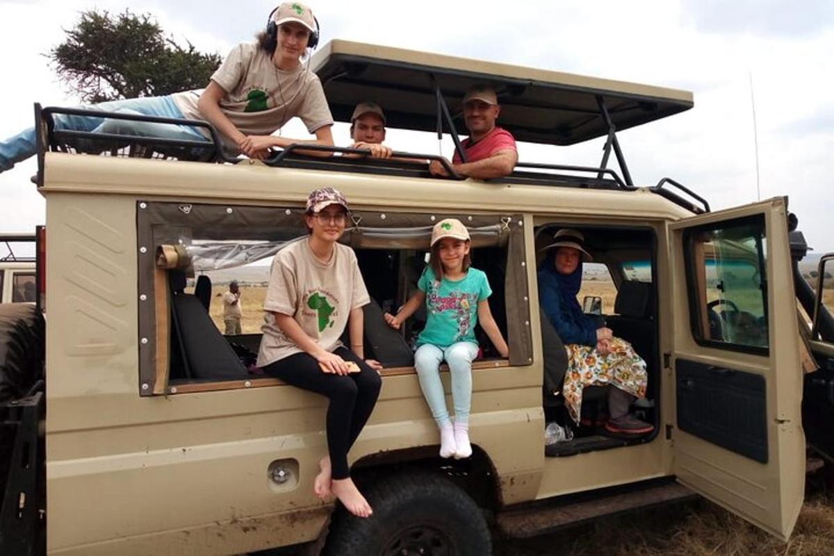 a group of people sitting on the back of a van