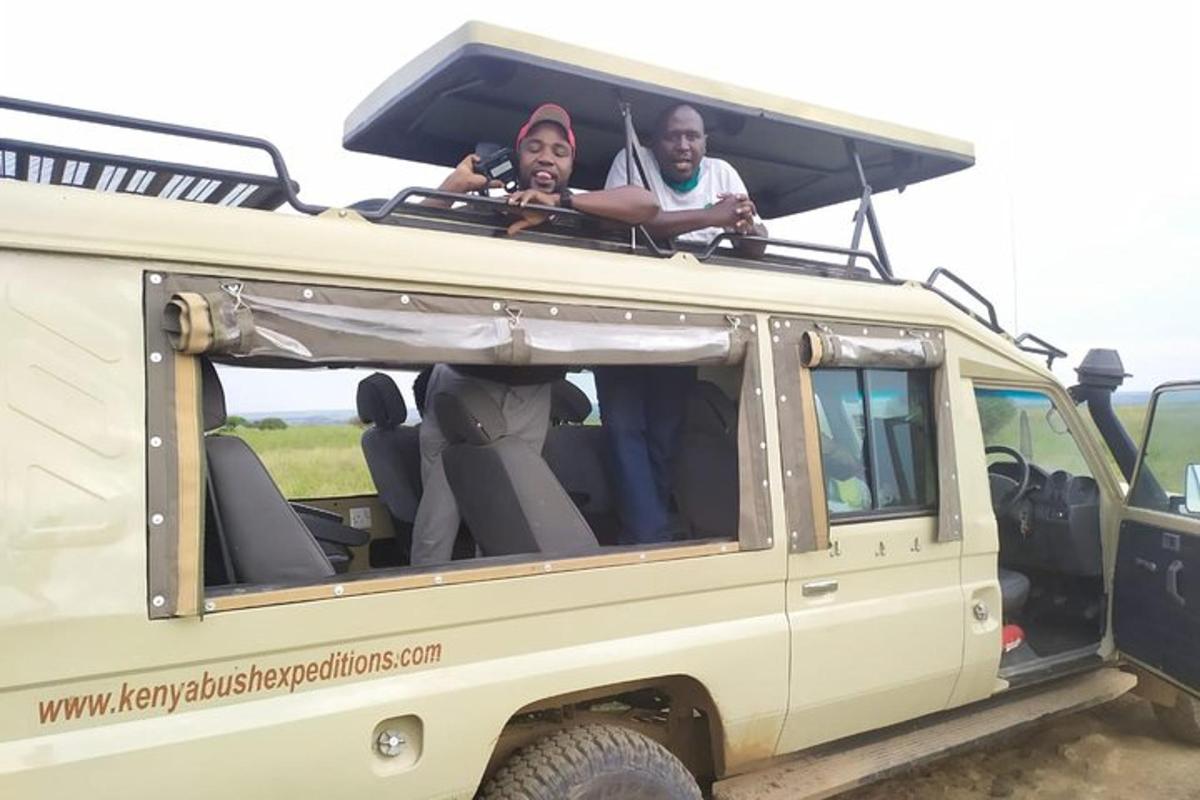 two people sitting in the back of a jeep
