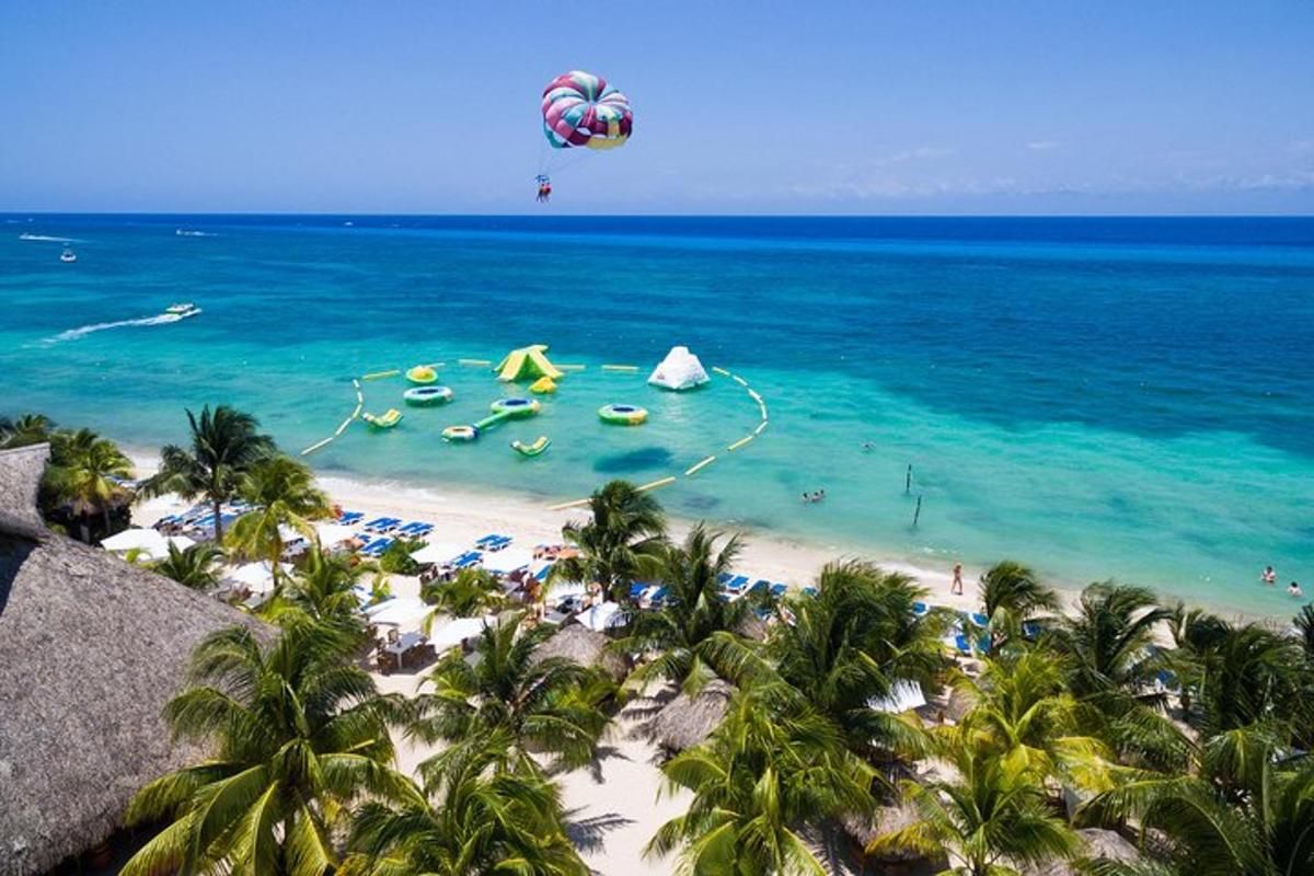 a beach with a bunch of people in the water