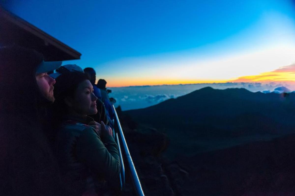 a group of people sitting on top of a mountain