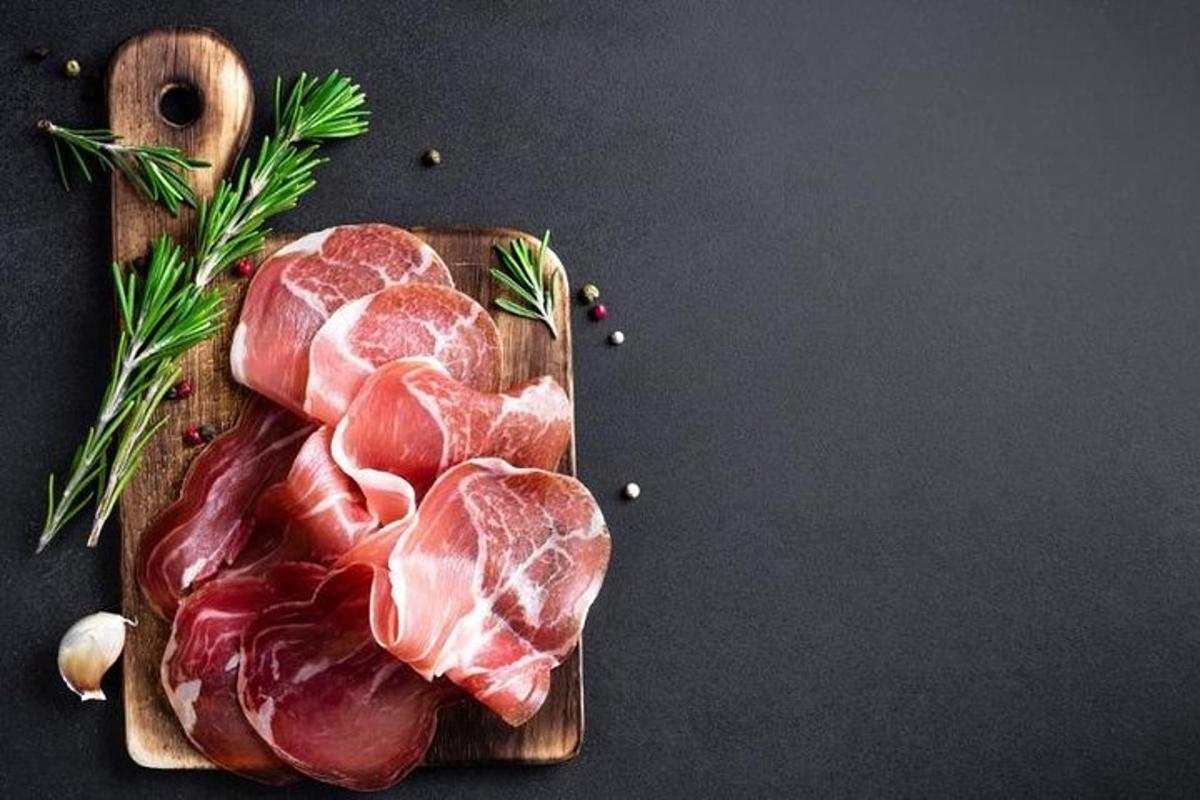 a wooden cutting board with meat on a table