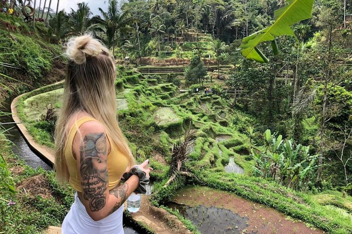 a woman with a tattoo pointing at a field