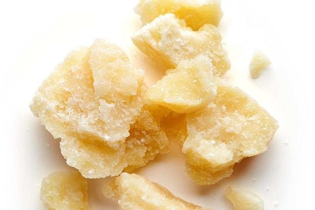 a pile of sugar crystals on a white surface