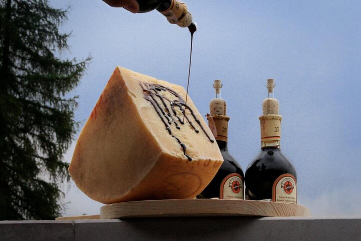 a person pouring wine into three bottles of cheese