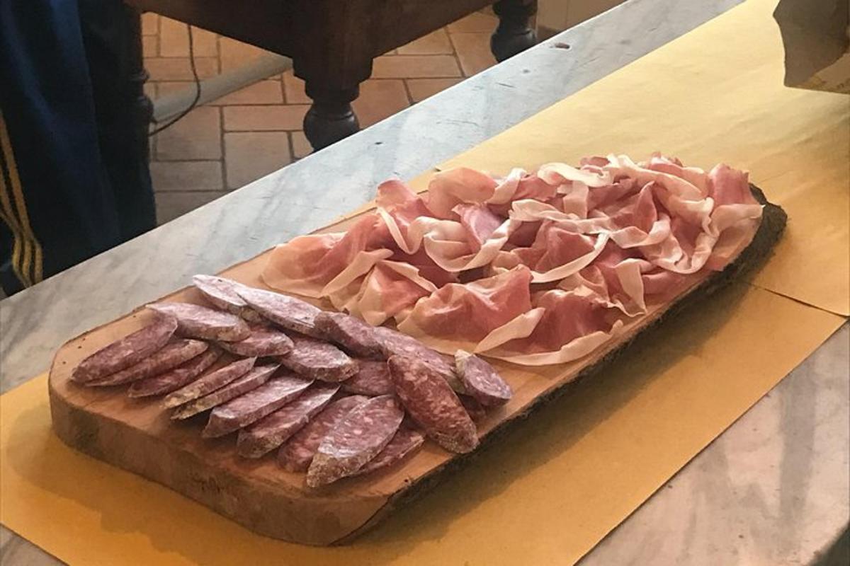a plate of meat and bacon on a table