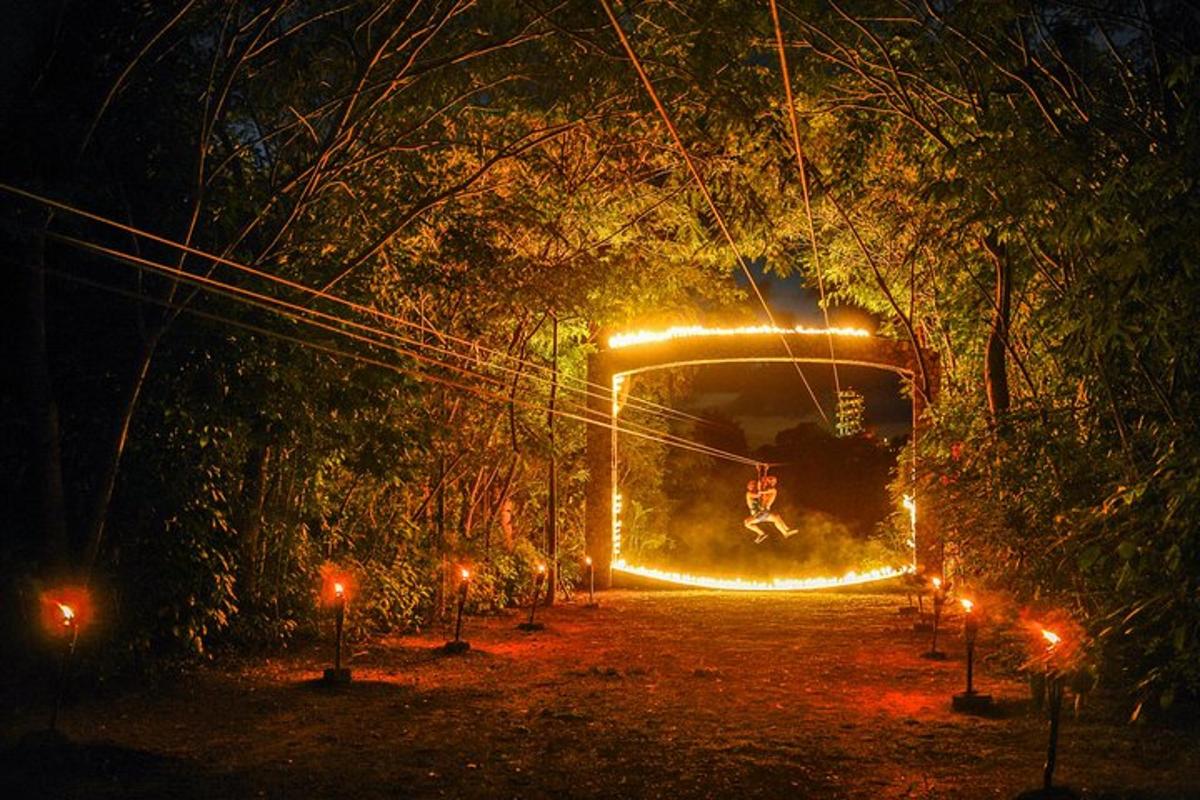 a person riding a zip line through a tunnel at night