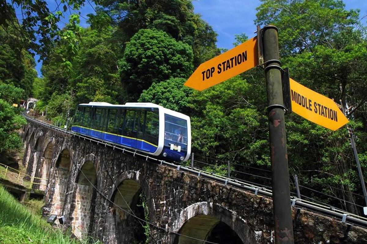a train on a bridge with a street sign