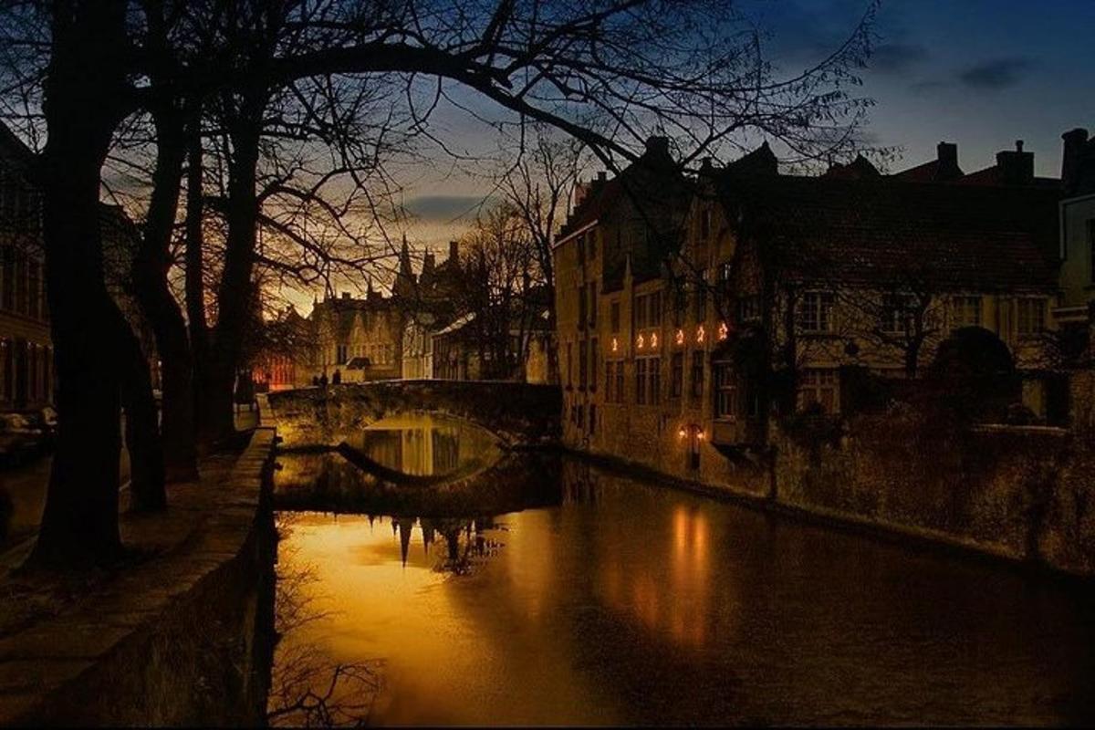 a river with a bridge in a city at night
