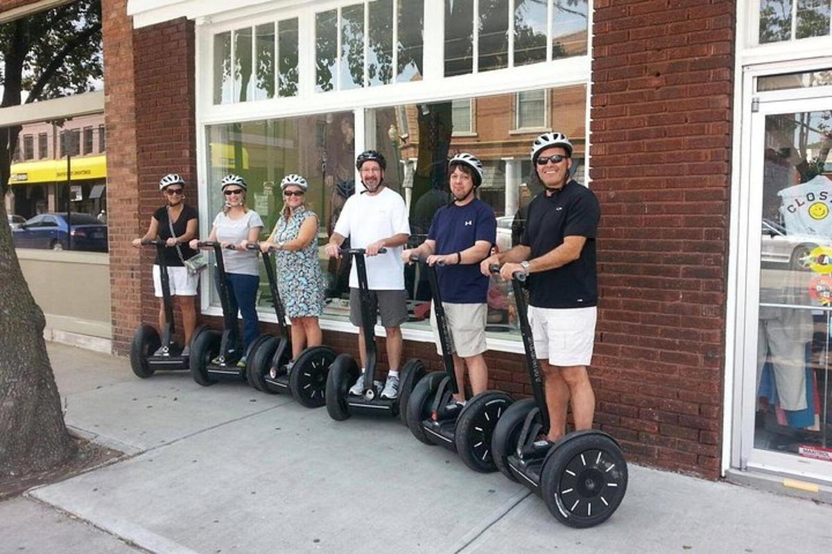a group of people standing on segways outside a building
