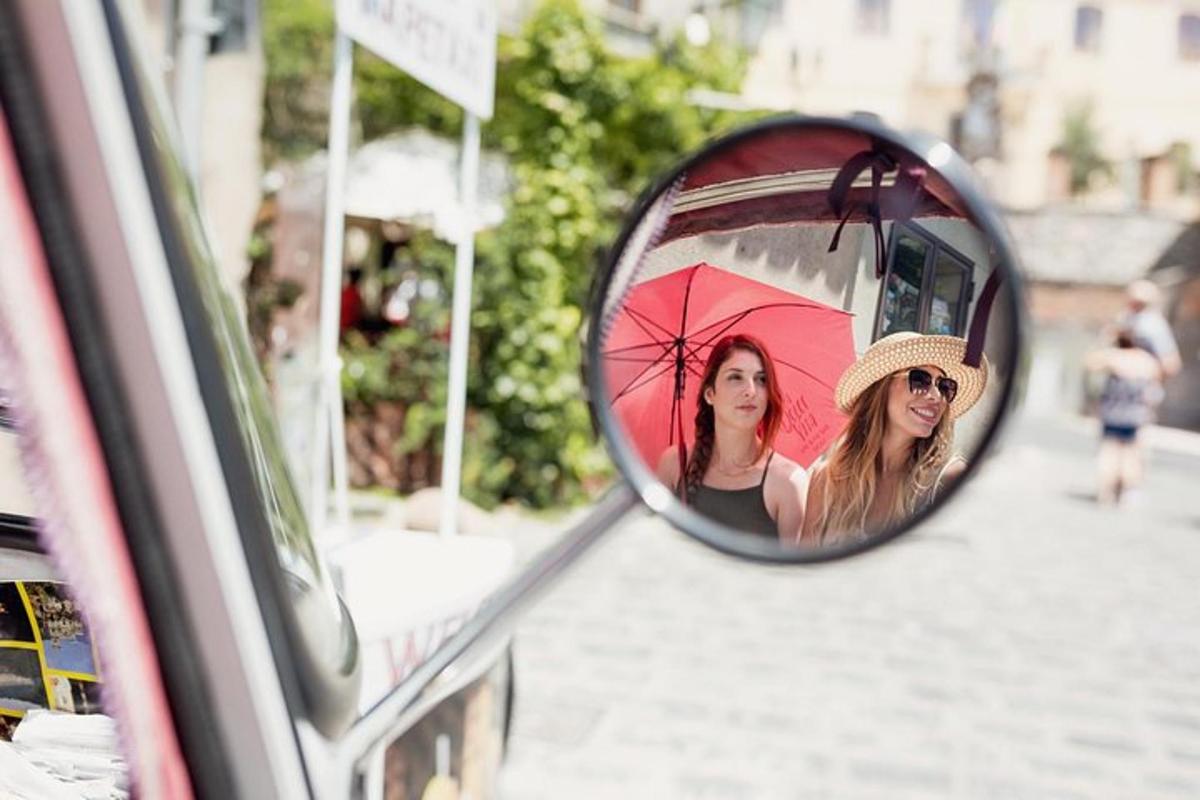 a reflection of two women in the side view mirror of a car