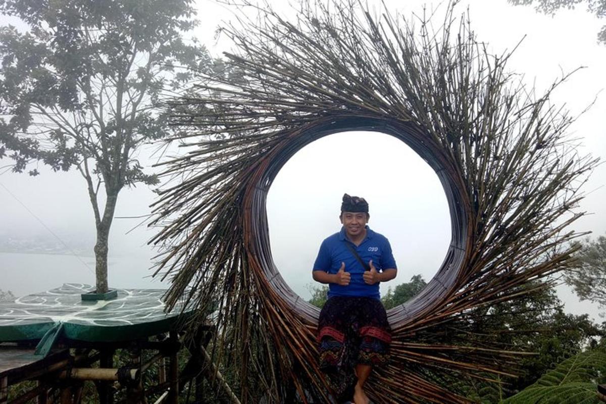 a man standing in front of a round mirror