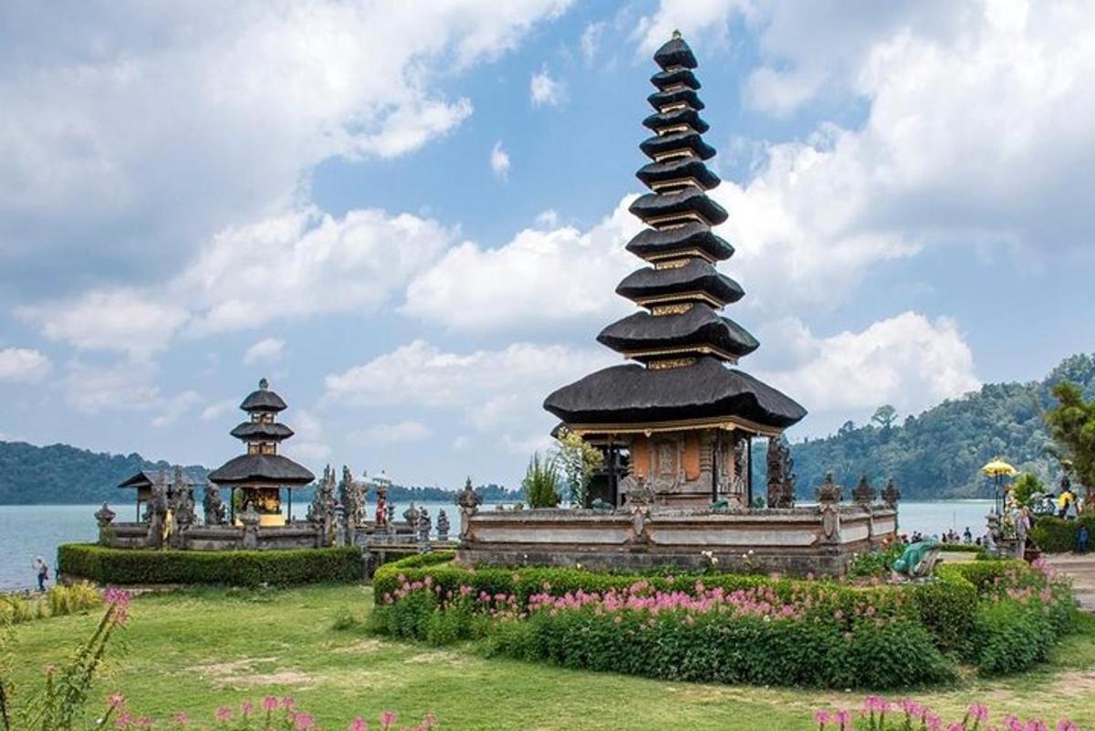 a pagoda in a park next to a body of water