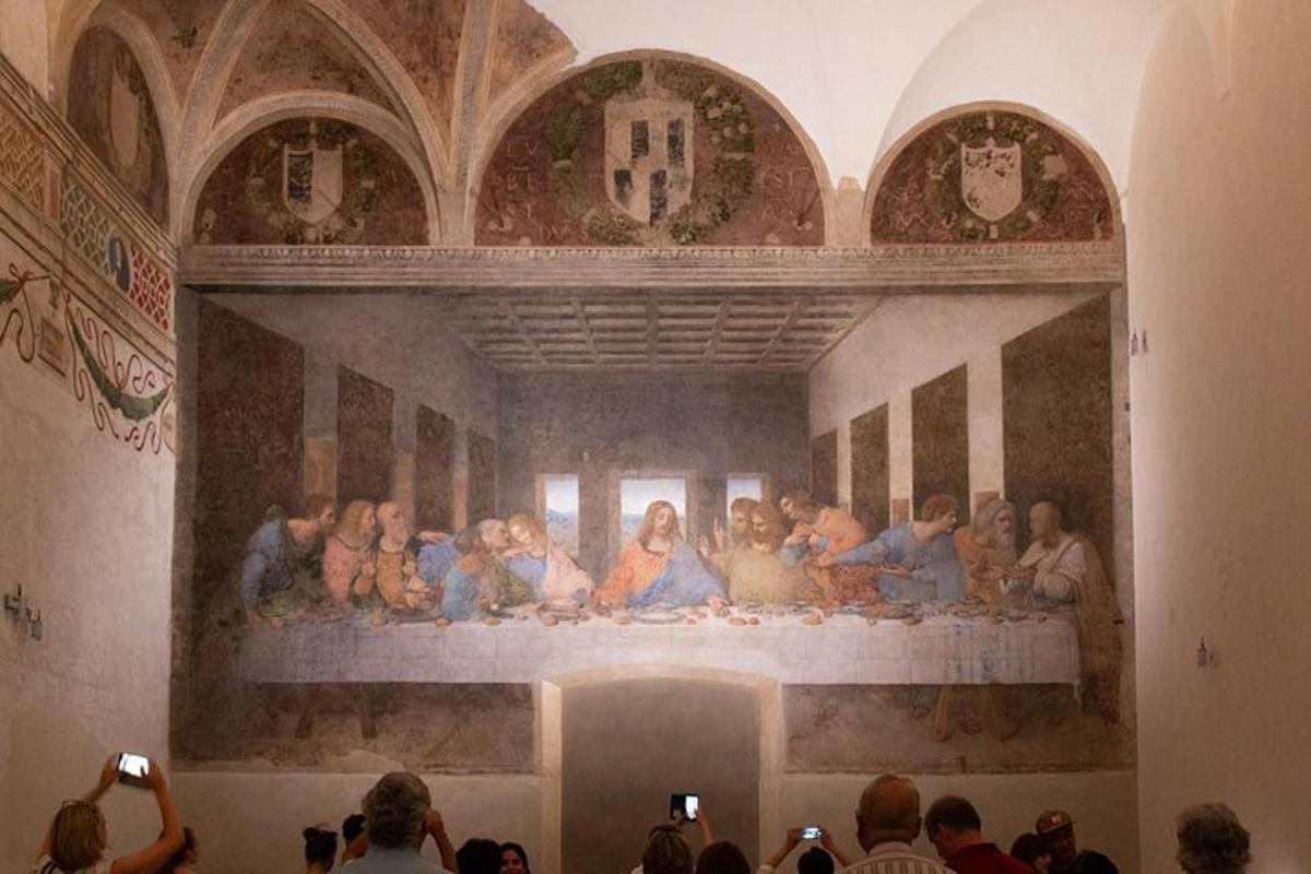 a crowd of people standing in front of a painting