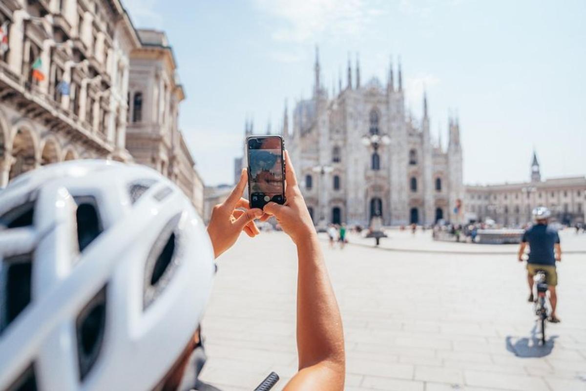 a person taking a picture of a building with a cell phone