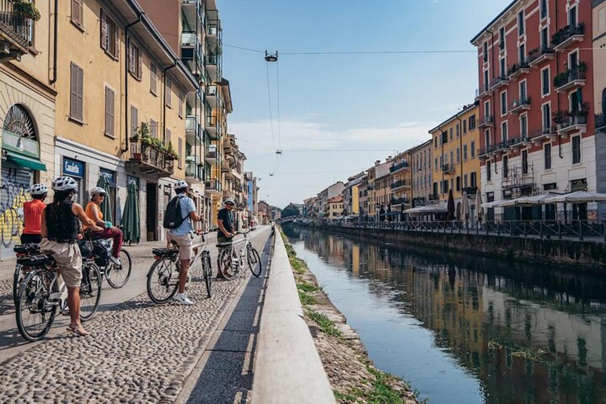 a group of people riding bikes down a canal
