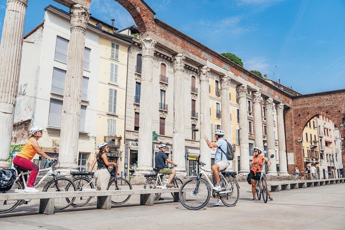 a group of people riding bikes in front of a building