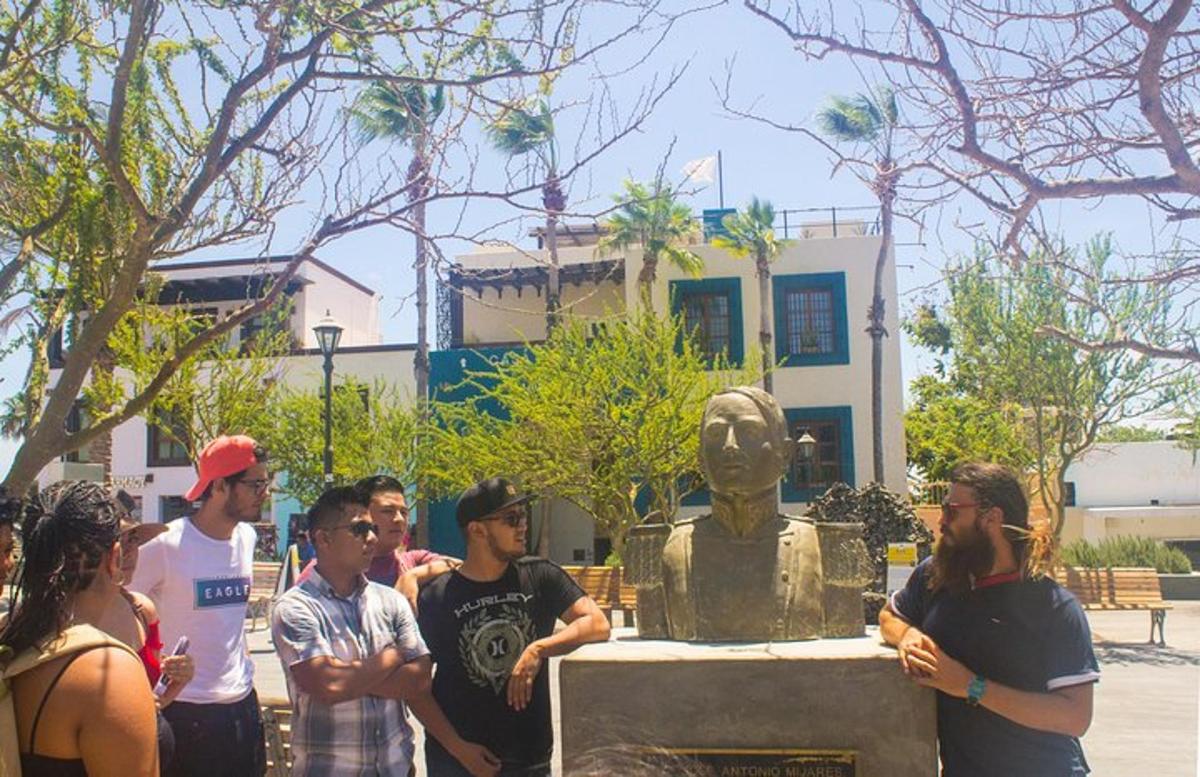 un gruppo di persone in piedi davanti a una statua