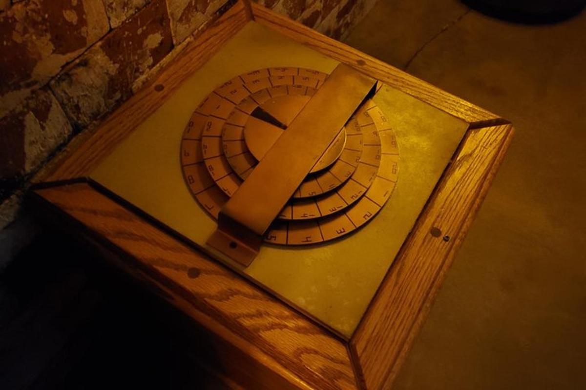 a clock in a wooden box with a ribbon on it