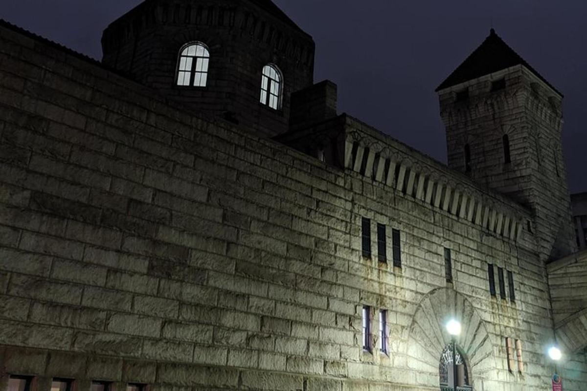 a large brick building with a clock tower at night