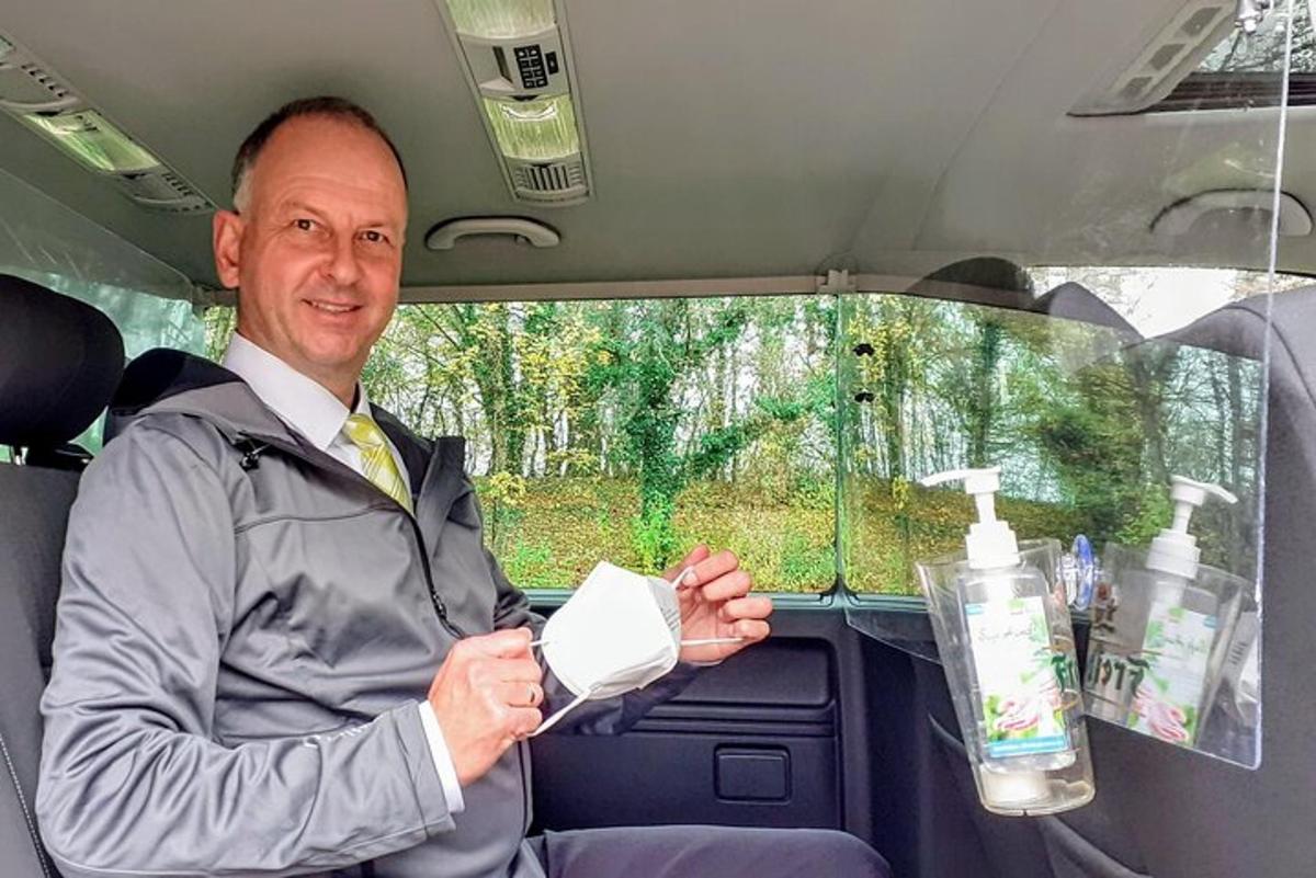 en mann som sitter i baksetet på en bil