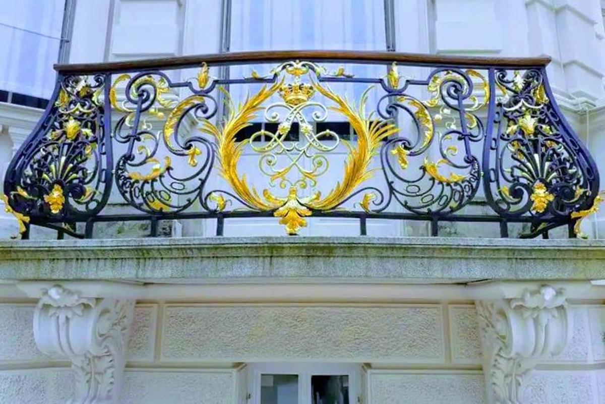 balkon s modrozlatým zábradlím na budově