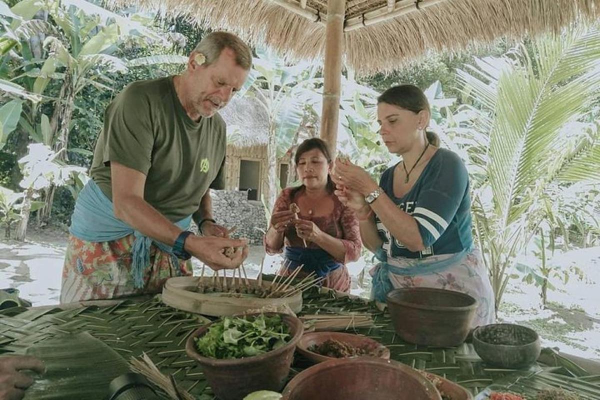 a group of people standing around a table with food