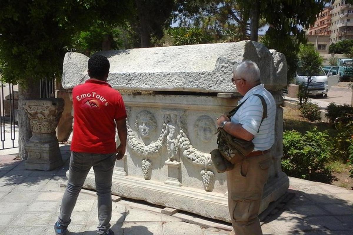 two men are standing next to a stone wall