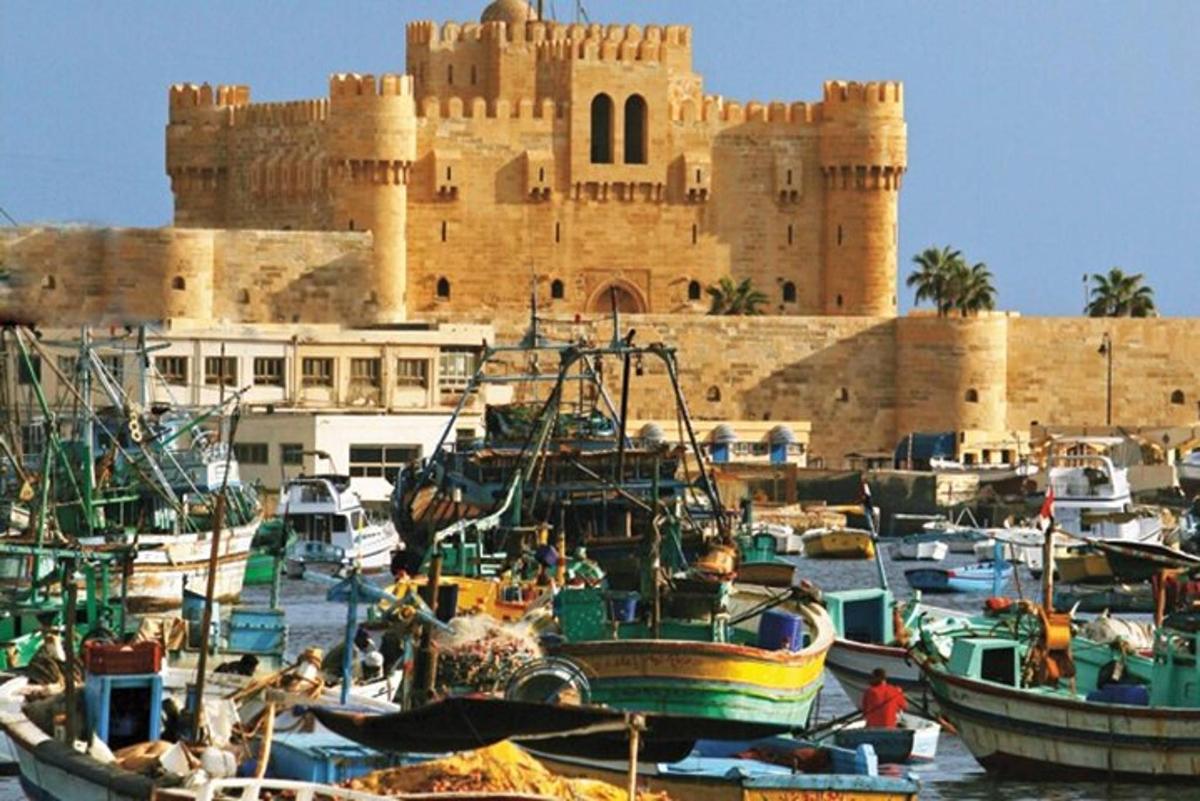 a group of boats in the water in front of a castle