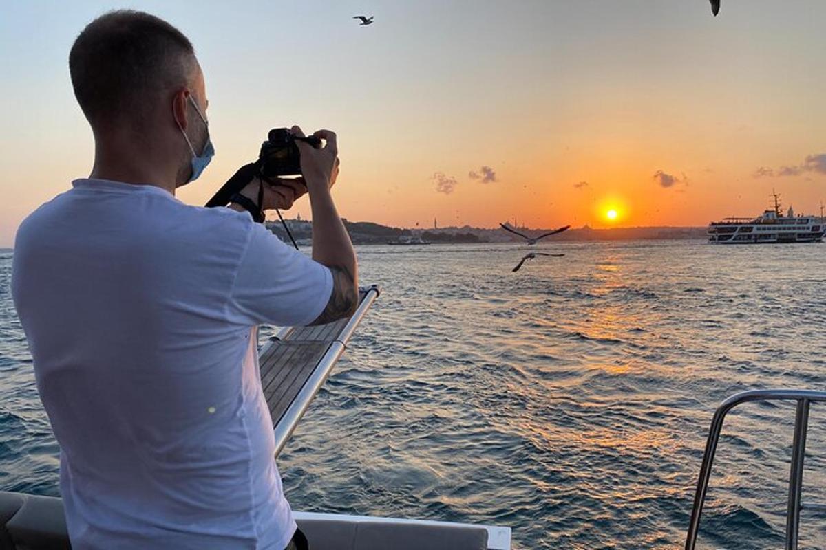 a man taking a picture of a bird in the water