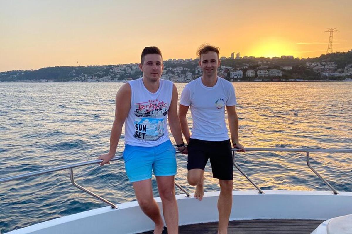 two men standing on a boat in the water