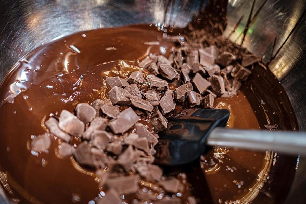 a pot of chocolate being stirred with a spatula