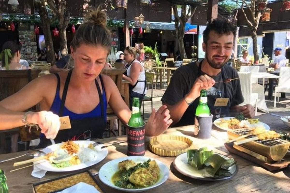 a man and a woman sitting at a table with food