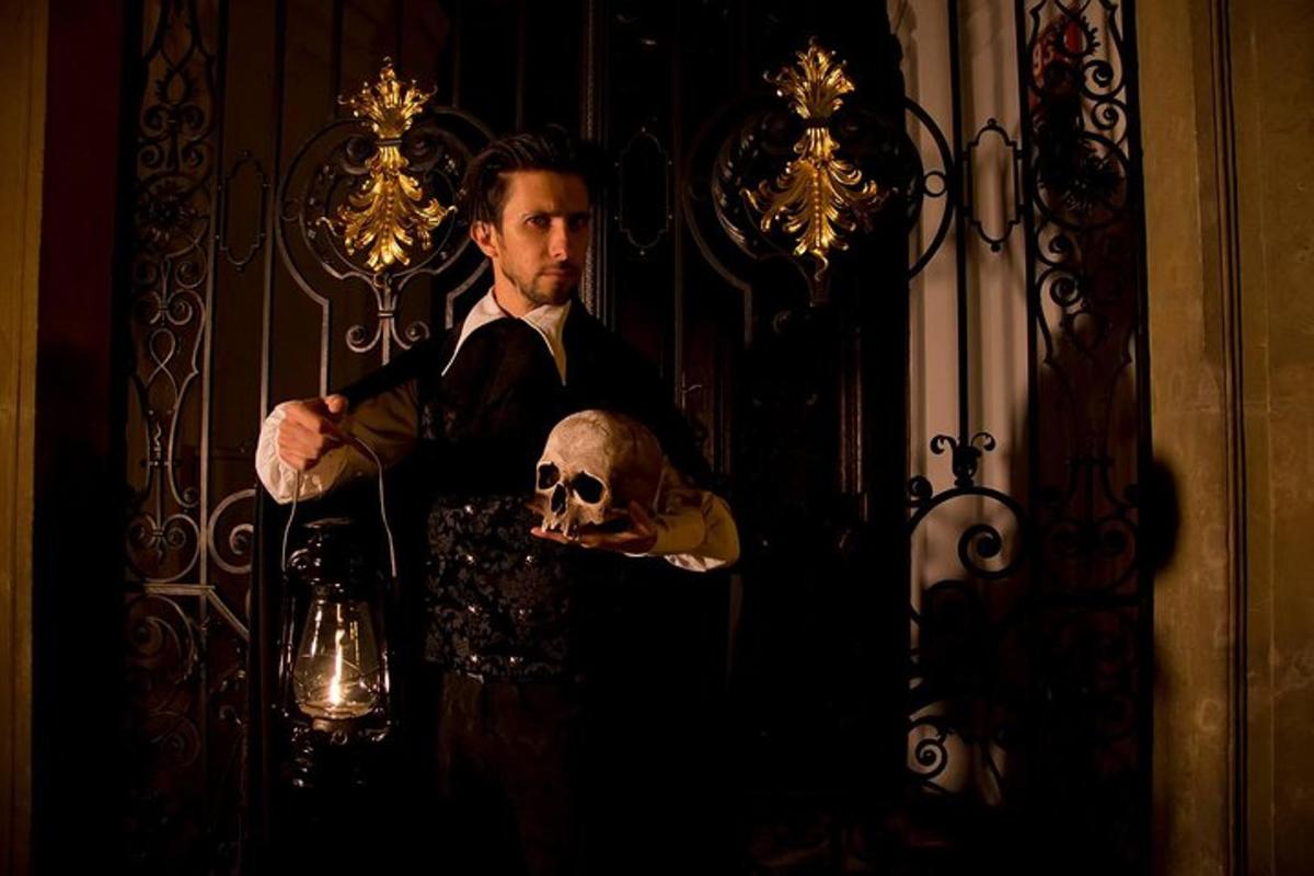 a man in a tuxedo holding a skull