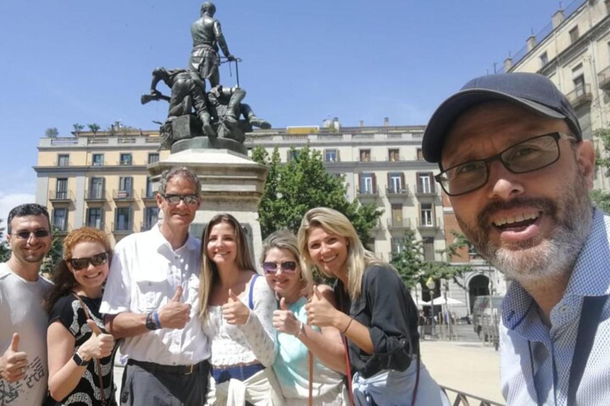 a group of people standing in front of a statue