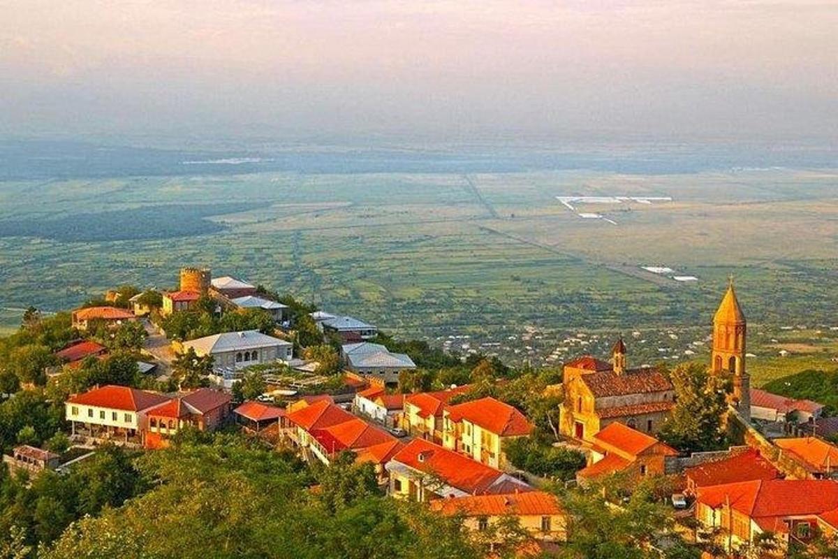 a town on top of a hill with a church