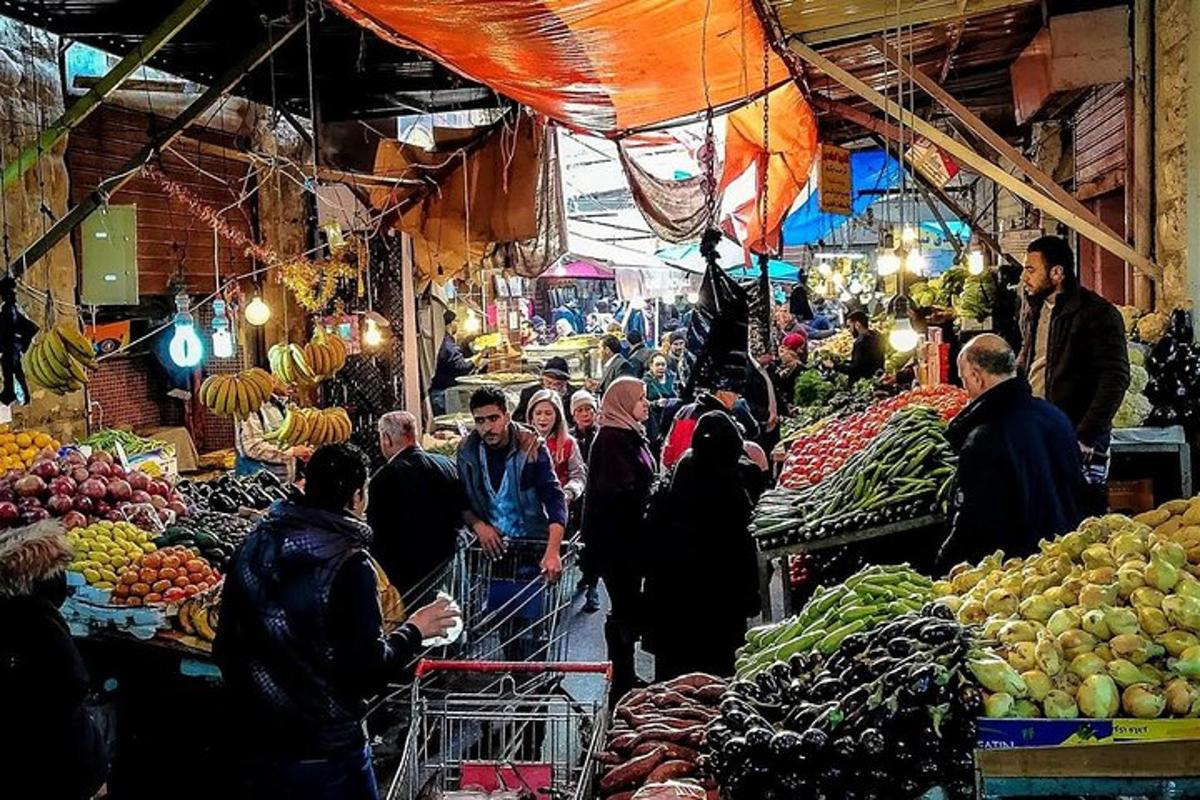 a group of people in a market with fruits and vegetables