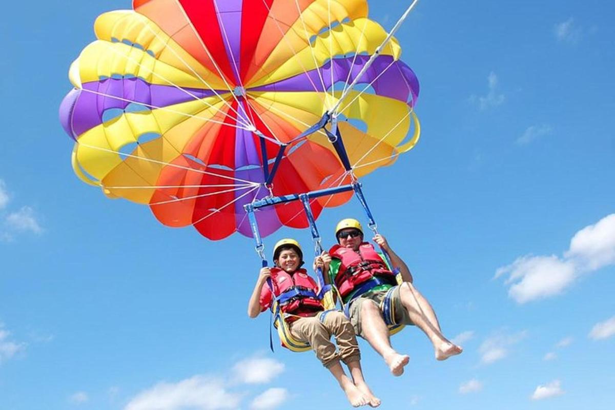 two people are riding a parachute in the sky